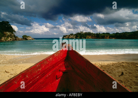 Boy and red boat on Boston Beach, Dragon Bay, Province of Portland, Jamaica, Caribbean