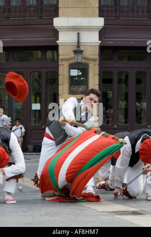 Man waving Basque national flag, the Ikurrina, during folk dance Plaza Arriaga Bilbao Pais Vasco Basque Country Spain Europe Stock Photo