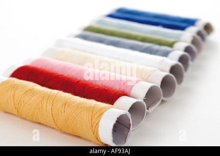 Spools of thread in a row, close-up Stock Photo