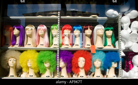 a display of elaborate wigs in a shop window Stock Photo