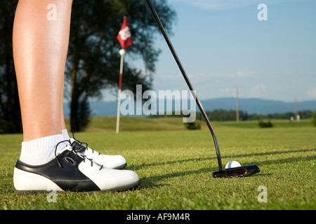 Woman playing golf, close-up Stock Photo
