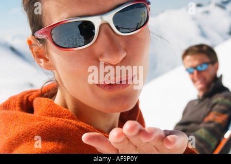 Couple in mountains, woman blowing kiss Stock Photo