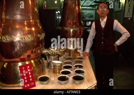 Hong Kong,Asia,Asian Far East,Eastern,Orient,Chinese,China,communism,communist,Kowloon,Nathan Road,tea,vendor vendors seller sell selling,stall stalls Stock Photo