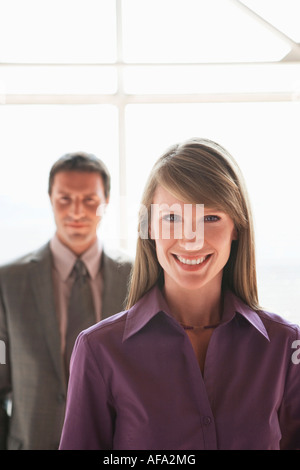 Two businesspeople, man and woman smiling Stock Photo