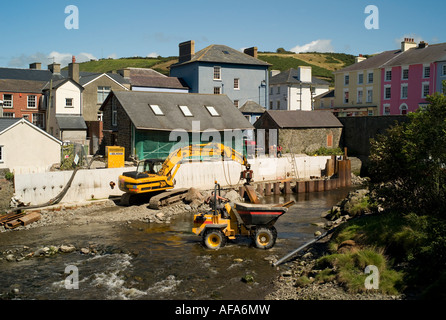 Dumper truck and JCB digger in the river Aeron Aberaeron west wales repairing sea or river wall damaged by torrential floods Stock Photo