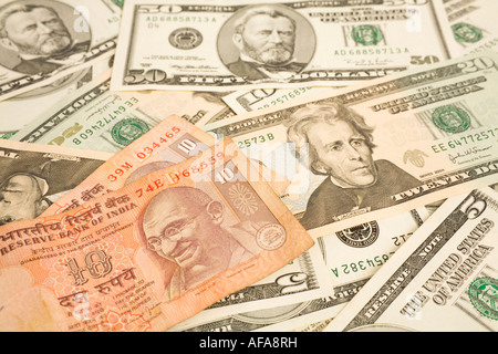 Indian rupee notes on top of dollar bills Stock Photo