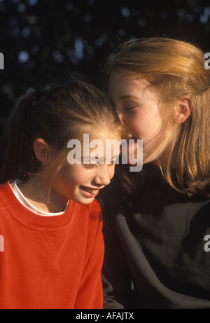 Girls laughing together Stock Photo - Alamy