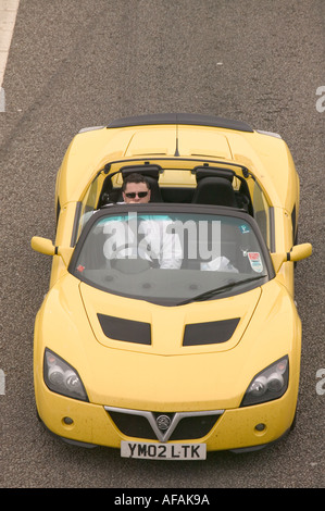 an open topped sports car on the M1 motorway at Kegworth Leicestershire Stock Photo