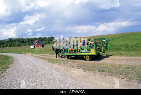 A wagon carries visitors to the headquarters of the U Bar Ranch a historic cattle ranch on the great Plains near Calgary, Alberta, Canada. Stock Photo