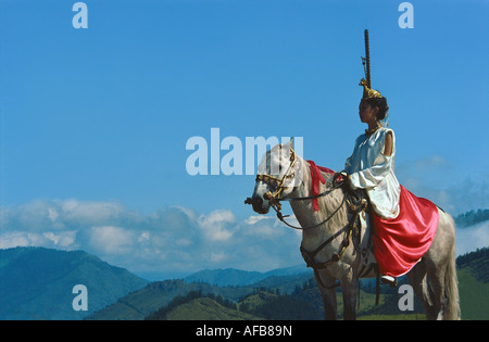 Horse-riding woman in raiment created in Pazyryk culture style. El-Oiyn - national festival of Altaic people. Russia Stock Photo