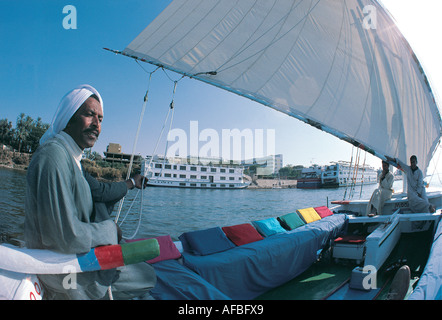 Egyptian sailor at the helm of his FELUCCA on the River Nile at Luxor Egypt