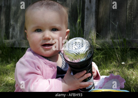 Baby girl with giant karaoke microphone Stock Photo