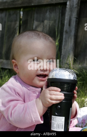 Baby girl with giant karaoke microphone Stock Photo