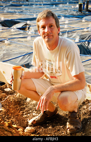 Man kneeling at construction site portrait Stock Photo