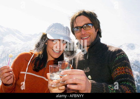 Couple having drink in mountains Stock Photo