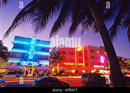 Glowing neon accents art deco era hotels along Ocean Drive at twilight Miami Beach Florida Stock Photo