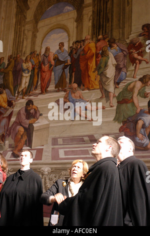 A group of priests view the the Raphael Rooms in the Vatican Museum, Rome. Stock Photo