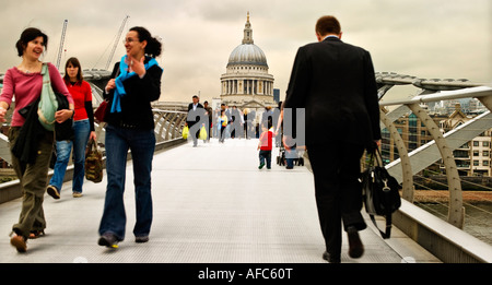 home from work sundown walking across millennium bridge St Pauls to Bankside London river straight path  happy relaxed briefcase Stock Photo