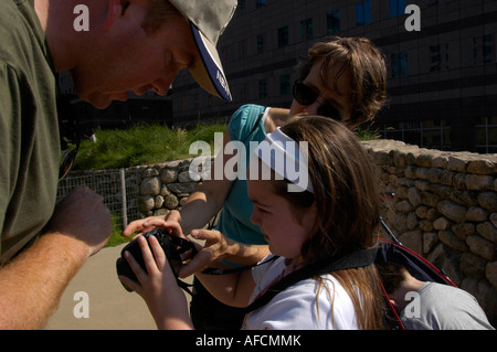 Seven year old learns the use of a camera at a visit to the Irish Hunger Memorial in NYC Stock Photo