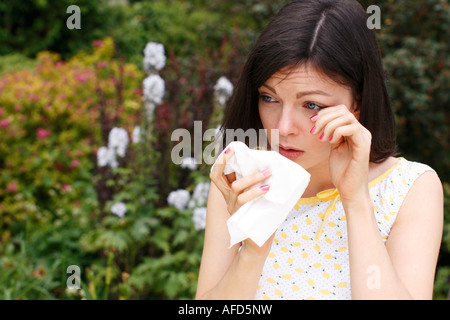 woman sneezing from hayfever Stock Photo