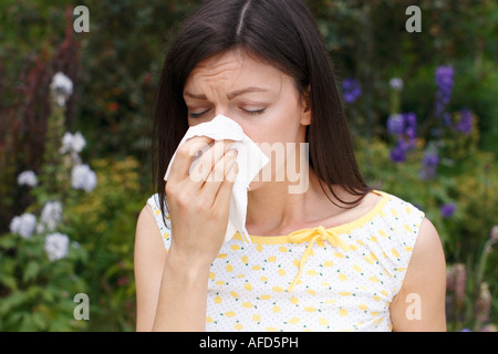woman sneezing from hayfever Stock Photo