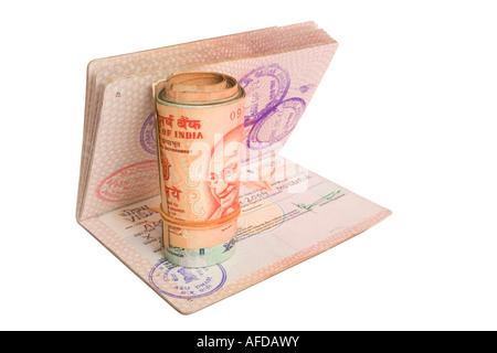 Roll of Indian Rupees on a British Passport with an Indian Visa. Isolated on White. Stock Photo