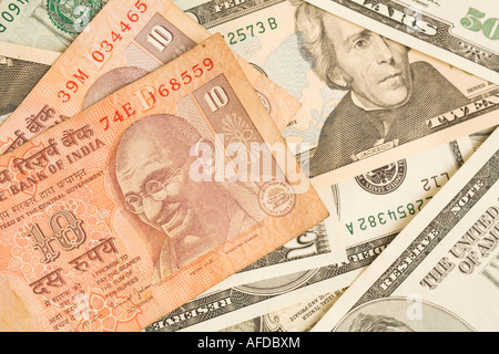 Indian rupee notes on top of dollar bills Stock Photo