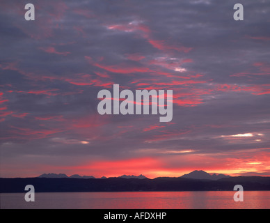 Red sunset sky over the hills of the Island of Skye, seen across the Sould of Sleat from Mallaig, Inverness-shire, Scotland Stock Photo