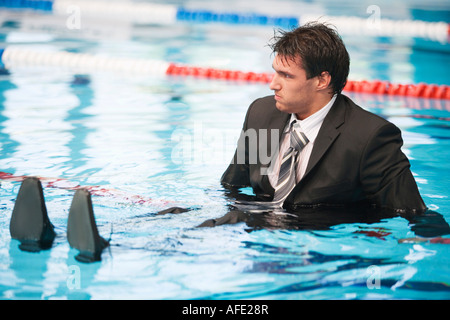 Businessman sitting in pool Stock Photo