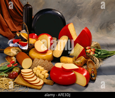 Holland Dutch Cheeses in group color photograph on warm toned mottled background. horizontal format, studio tabletop. Stock Photo