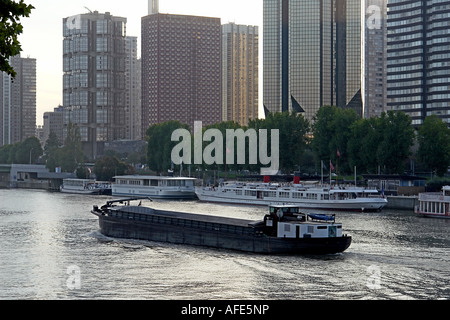 Canal boat on the river Seine in front of Issy les Moulineaux quays early in the morning - Paris Stock Photo