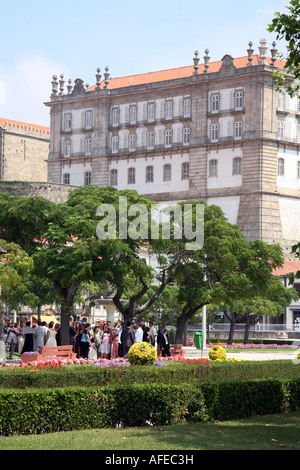 People in the park at a wedding reception against a backdrop of the Convent of Santa Clara, Vila do Conde, Northern Portugal Stock Photo