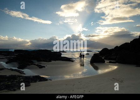 Couple on a romantic dawn beach walk at Little Cove on the Gold Coast Australia