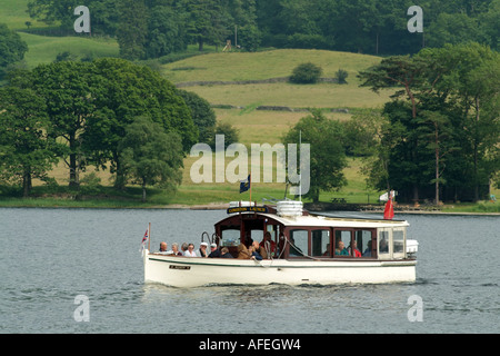 Solar electric launch on Coniston Water. Lake District Cumbria northern England UK Stock Photo