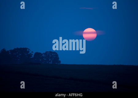 Setting Sun over rural landscape Stock Photo