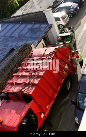 Refuse lorry collecting commercial property rubbish Stock Photo