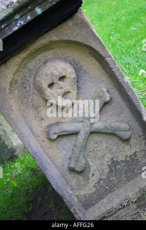 A tomb with a skull and crossbones on it. Eyam, Derbyshire, United Kingdom. Stock Photo