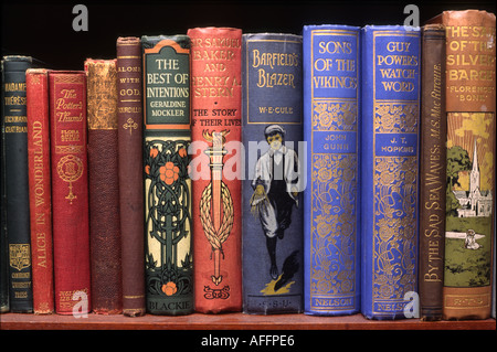 Reading line of old books on shelf Stock Photo