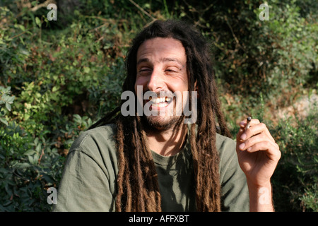 hippy preparing rolling and smoking marijuana joint photos series Stock Photo