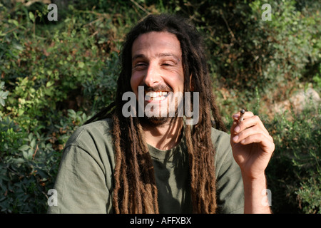 hippy preparing rolling and smoking marijuana joint photos series Stock Photo