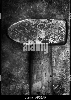 Closeup of battered heavy metal blacksmiths hammer on anvil Stock Photo