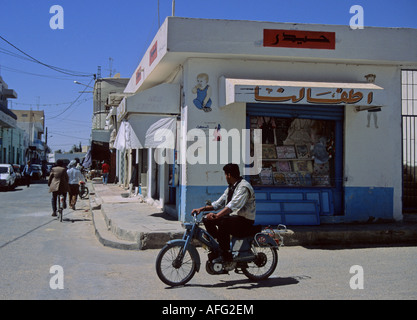 man on a monoped along a commercial street in Gabes Tunisa Northern Africa Stock Photo