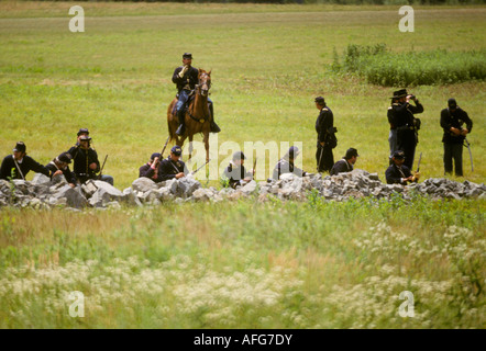 civil war reenactors Gettysburg PA battle field yankee northern army behind stone wall fence Stock Photo