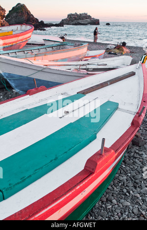 Wooden fishing boats resting on shore of beach in Nerja Spain Stock Photo