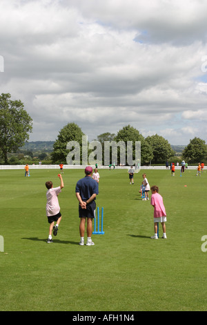 Young children practice cricket at a sport academy Stock Photo