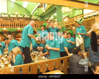 Europe Germany Munich Beer Festival Oktoberfest people dancing and drinking in tent hall and partying. Stock Photo