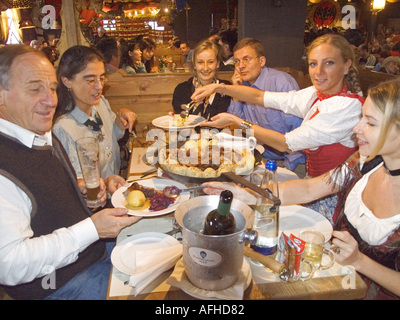 Europe Germany Munich Beer Festival Oktoberfest people dancing and drinking in tent hall and partying. Stock Photo