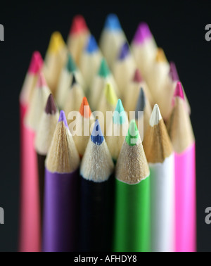 A bundle of coloured pencils stood with the points facing upwards with recession shot in the studio. Stock Photo