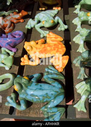 Colourful ceramic garden frogs on sale in garden centre, UK Stock Photo