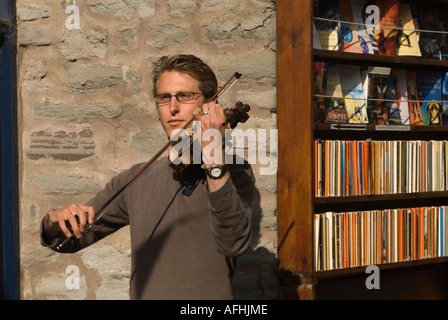 Young man a youth playing the violin, busking at the Hay Book Festival, Hay on Wye Powys Wales UK 2000s 2006 HOMER SYKES Stock Photo